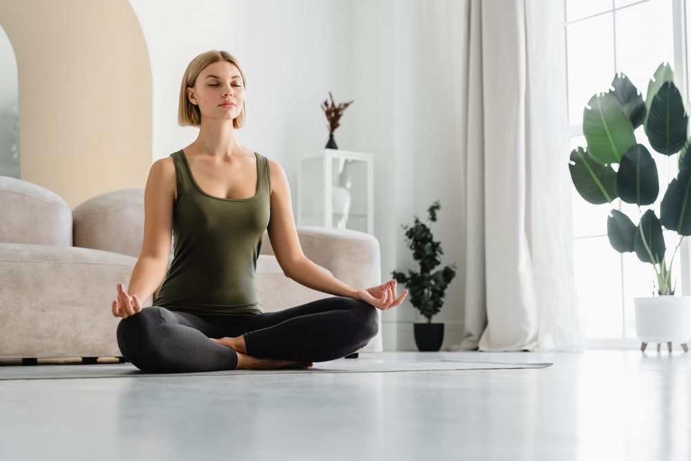 Relaxed,Young,Woman,Doing,Sitting,In,Yoga,Position,At,Home.