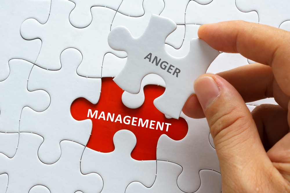 Hand,Holding,Piece,Of,Jigsaw,Puzzle,With,Word,Anger,Management.